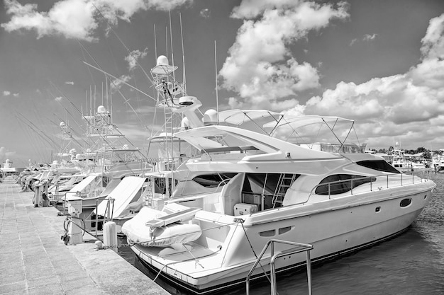 Yachts in bay with cloudy sky luxury yachts docked in the port\
in bay at sunny day with clouds on blue sky in la romana dominican\
republic
