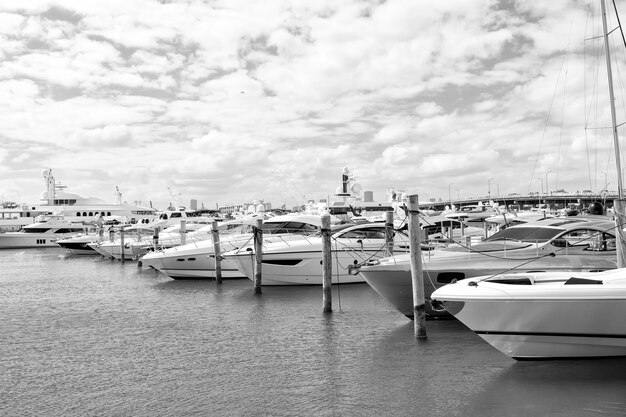 Yachts in miami marina bay at south beach with cloudy sky