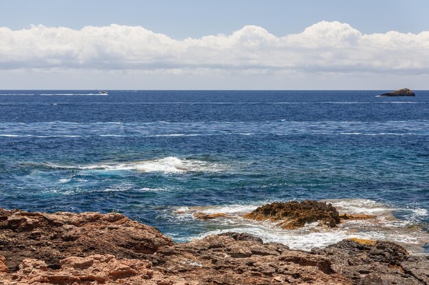 Yachts remained on the sea surface in the distance another boat Ibiza