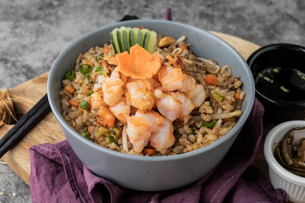 Yakimeshi, asian dish made with fried rice,  seafood and meat  in a bowl