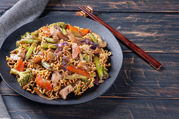 Yakisoba, famous Japanese fried noodles, with meat and vegetables. Top view