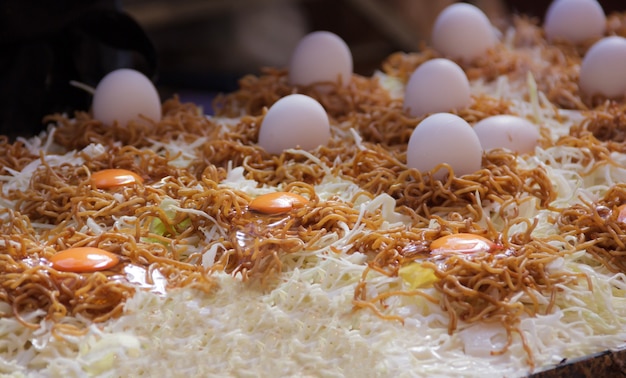 Yakisoba (Japanese fried noodles with bite-sized pork, vegetables) is prepared on hot pan