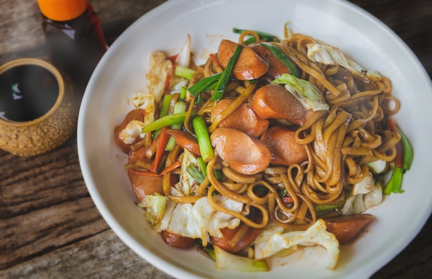 Yakisoba noodle with sausage on a plate