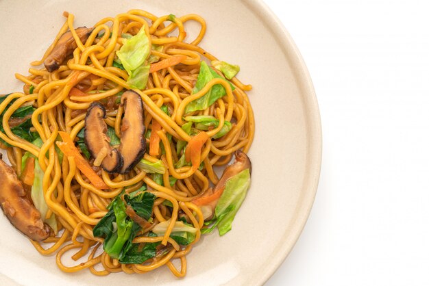 焼きそば麺は、白い背景-ビーガンとベジタリアン料理に分離された野菜と炒め