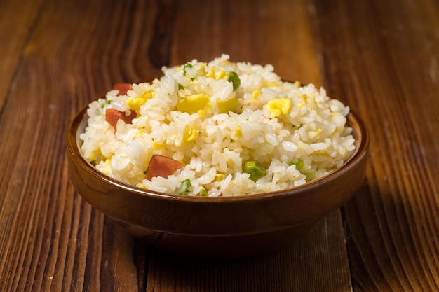 Yangzhou fried rice on wooden background