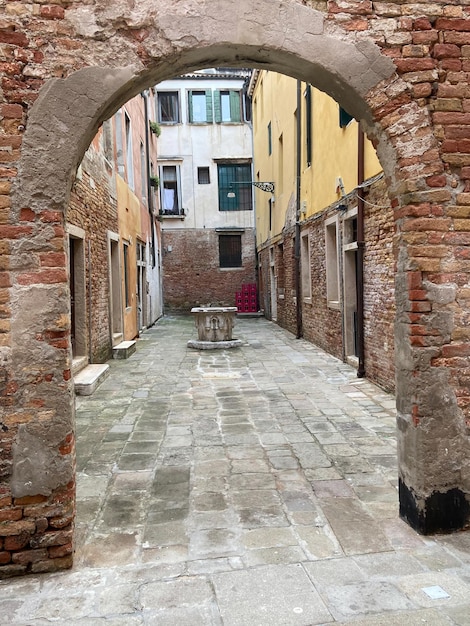 Yard with old well in Venice in winter evening