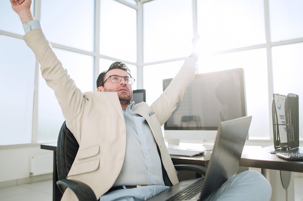 Yawning businessman sitting in front of the Desk