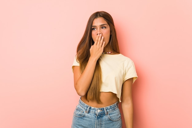 yawning showing a tired gesture covering mouth with hand.