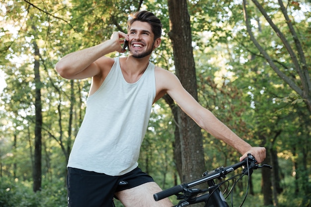 Сyclist talking on the phone in forest