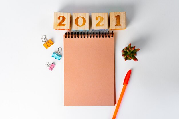 Year 2022 numbers and stationery on white table