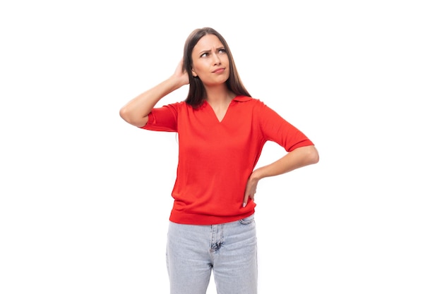 year old caucasian woman with straight dark hair is dressed in a red shirt on a white background