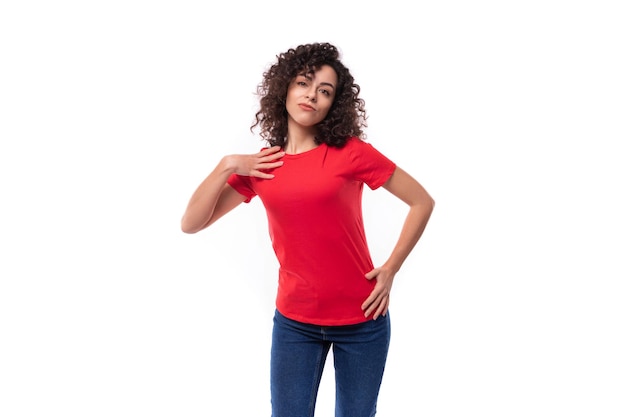 year old slim brunette woman dressed in a red basic tshirt on a white background with copy space