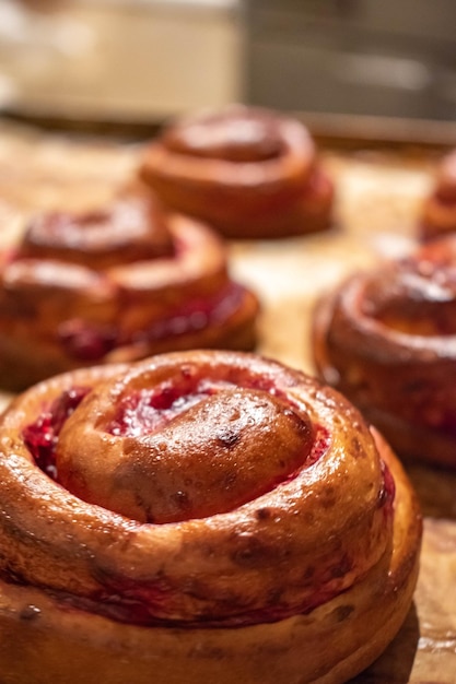 Yeast buns with jam on a baking tray