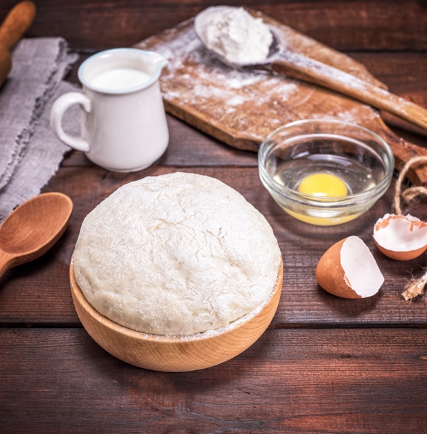 Yeast dough in a wooden bowl