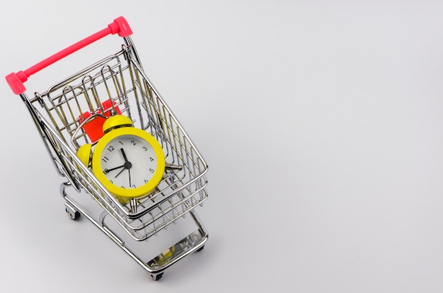 Yellow alarm clock in a shopping trolley