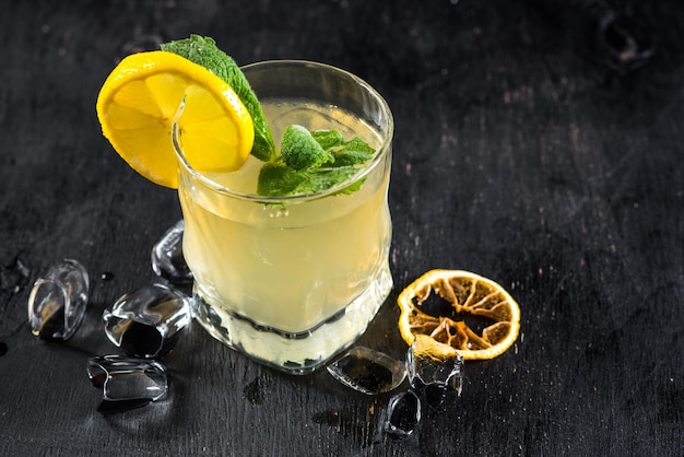 Yellow alcohol drink in glass on black background