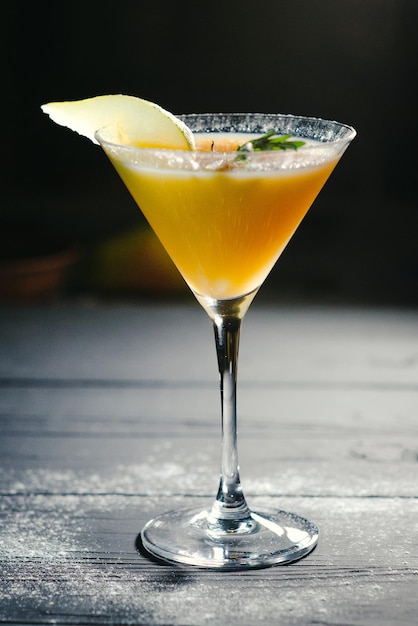 yellow alcohol pear cocktail pear on dark background