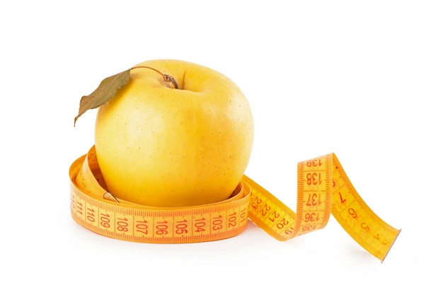 Yellow apple with measuring tape isolated on white background.