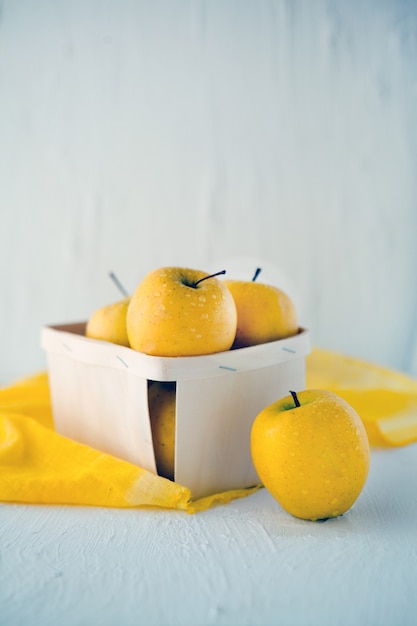 yellow apples at the basket on white background  concept for healthy nutrition front view