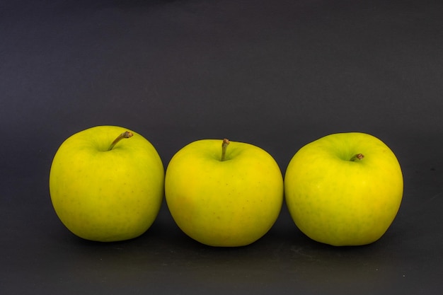 Yellow apples on a black background