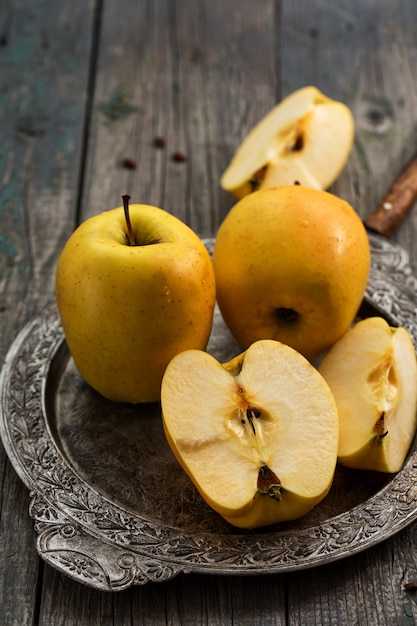 Yellow apples lobe on a metal tray