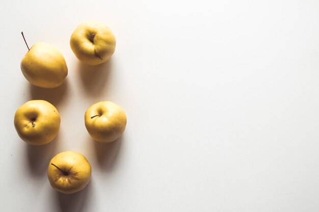 Yellow apples on a white background, wholesome food, farming, vegetarian