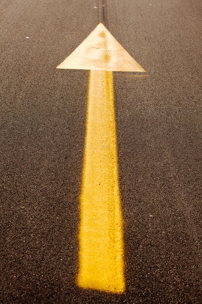 Yellow arrow on asphalt