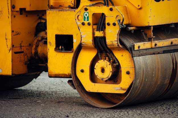 yellow asphalt compactor aligns the road. Laying new asphalt.