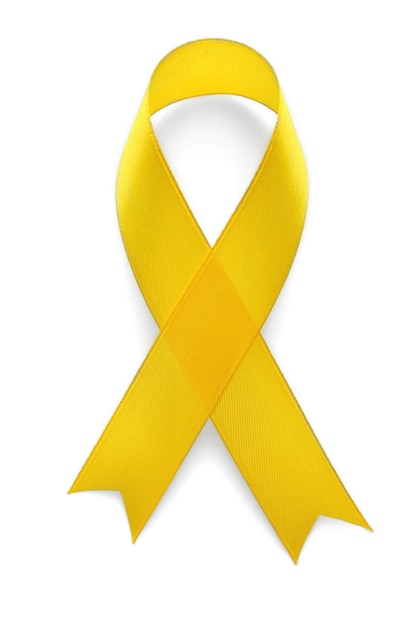 Yellow awareness ribbon on light background