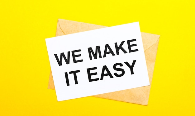 Photo on a yellow background, an envelope and a card with the text we make it easy. view from above