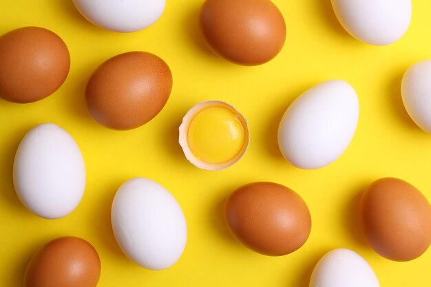 A yellow background with eggs and one that is white