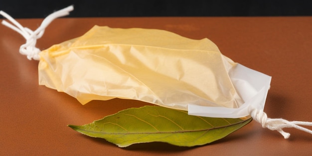 A yellow bag with a green leaf on it