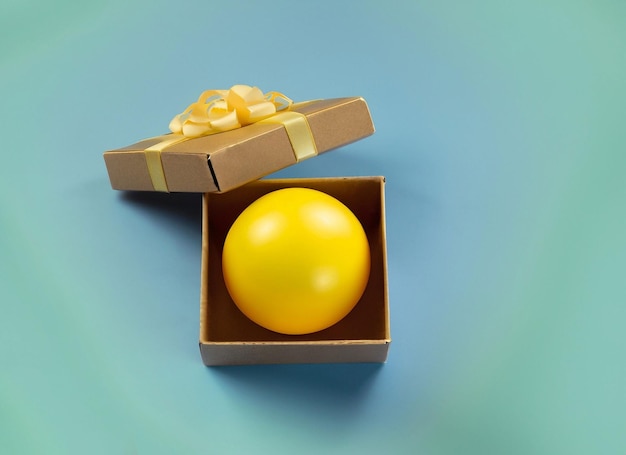 Yellow ball in boxgift or surprise conceptsfunny background