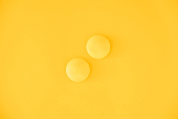 Yellow balls on yellow background. Minimal concept. Top view. Copy, empty space for text