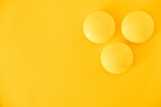 Yellow balls on yellow background. Minimal concept. Top view. Copy, empty space for text