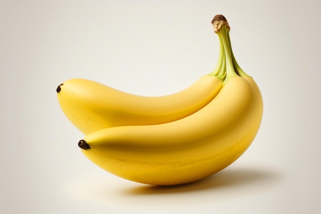 A yellow banana with a green stem is sitting on top of it.