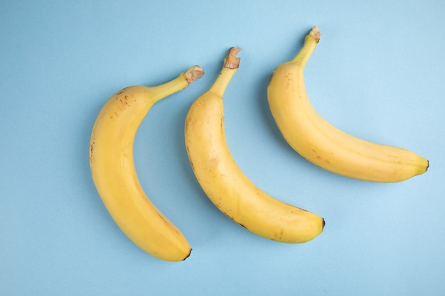 Yellow bananas on a blue surface