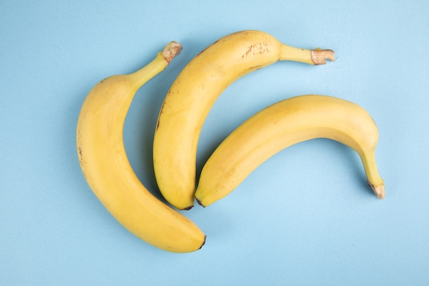 Yellow bananas on a blue surface