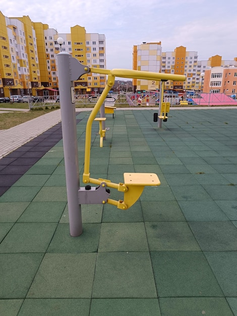 A yellow bar is on the ground in front of a building.