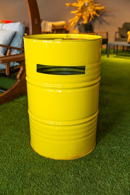 A yellow barrel with a hole in the middle of it