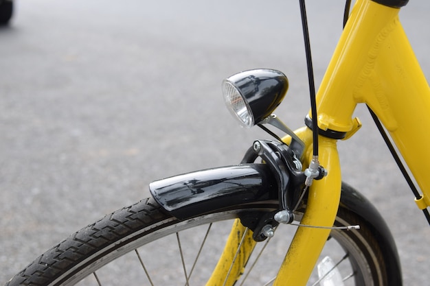 Yellow bicycle in the public park.