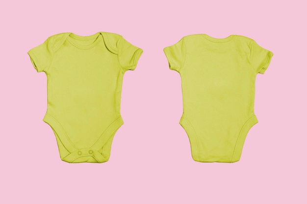 Yellow blank baby bodysuit template, closeup mockup on pink background. Front and back side. Baby bodysuit, jumpsuit for newborns. View from above