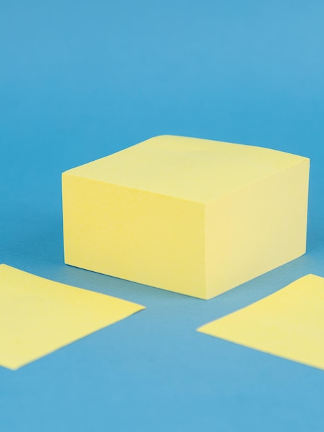 Yellow blank sticky paper sheets isolated on blue background