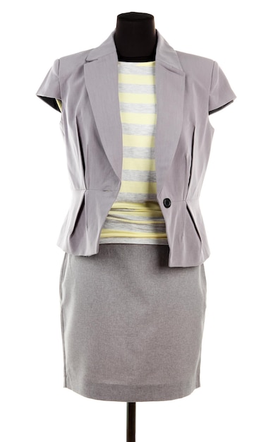 Yellow blouse gray jacket and gray skirt on mannequin isolated on white