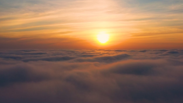 Yellow and blue dawn over clouds