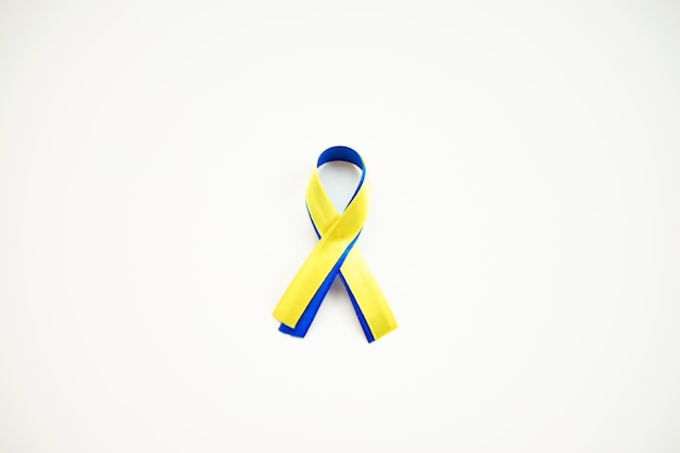 yellow blue ribbon on a white background. a sign of support for Ukraine. colors of the Ukrainian fla