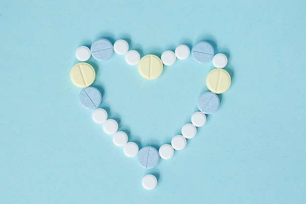 Yellow, blue and white tablets on a blue background