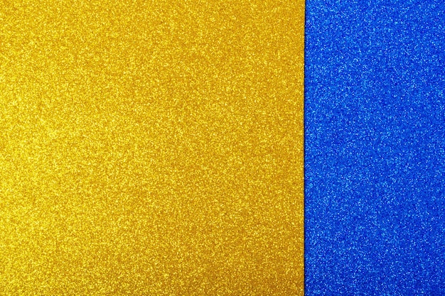 Yellow and blue wrapping paper background with metallic sheen Double color yellow blue shiny paper background copy space Fashion texture minimal concept flat lay top view