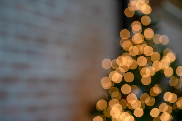 Yellow blurred bokeh on cristmas tree in the room and soft focus beautiful color for background and