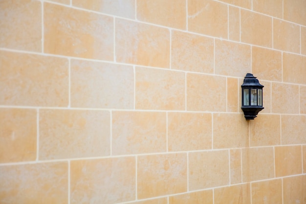 Yellow brick wall and the old lamp